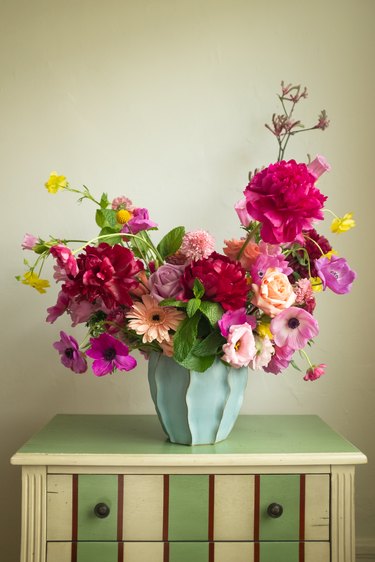 floral arrangement on striped dresser