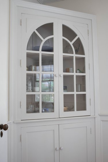 White corner cabinet with white knobs