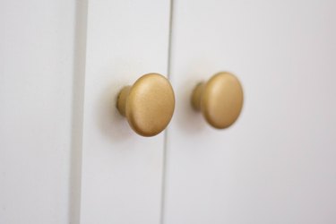 Cabinet knobs painted with a raw brass finish