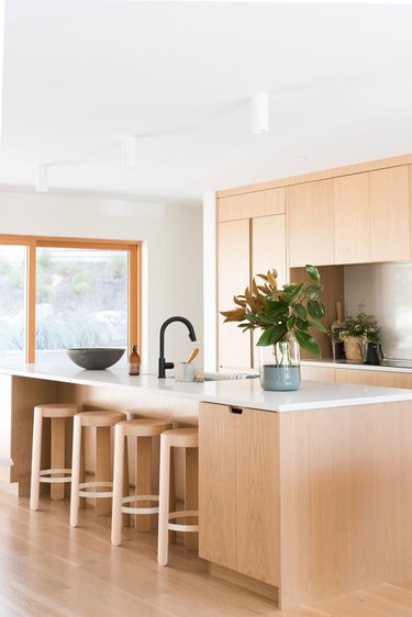 light wood kitchen cabinets with white countertops