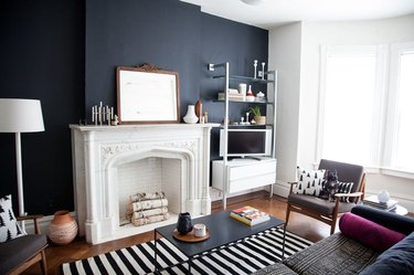 black living room walls with white fireplace