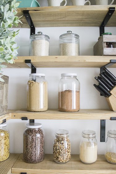 Pantry shelves with jars and brackets.