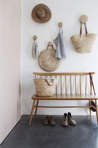 wall hooks in entry hallway with wooden bench