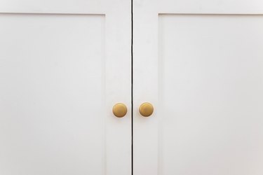 Knobs painted brass and attached to cabinet