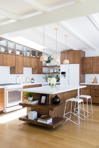 Midcentury kitchen island idea with wood cabinets and white countertops