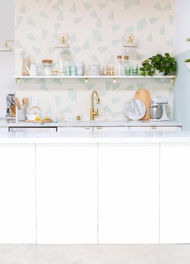 colorful terrazzo pattern tile kitchen backsplash with open shelving and white cabinets