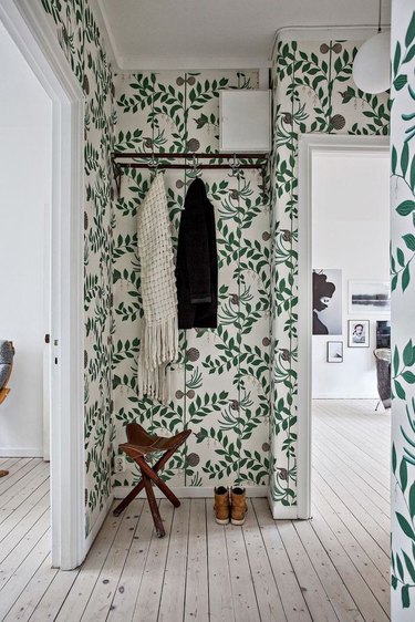 foliage covered wallpaper in small hallway