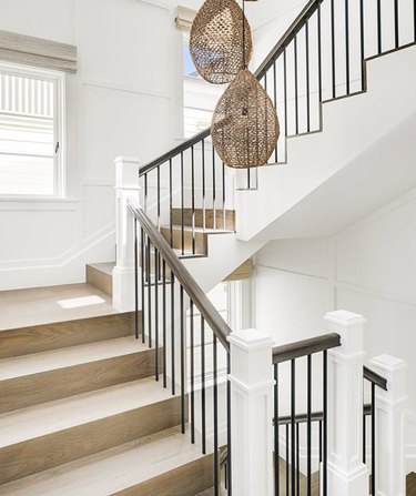 attic stairs ideas with light wood, metal and white staircase with wicker pendant lamps.