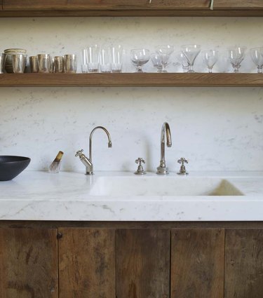 marble countertops and backsplash with integrated sink in rustic kitchen