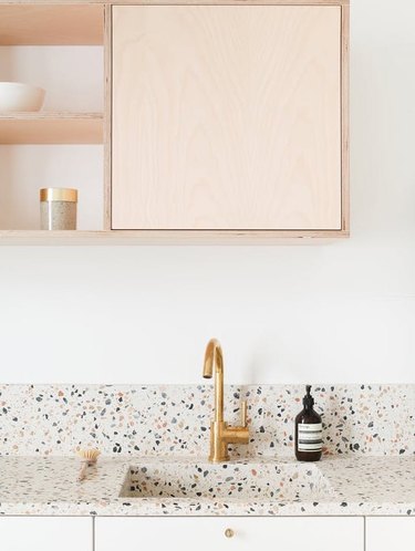 Scandinavian kitchen with terrazzo countertop and integrated sink