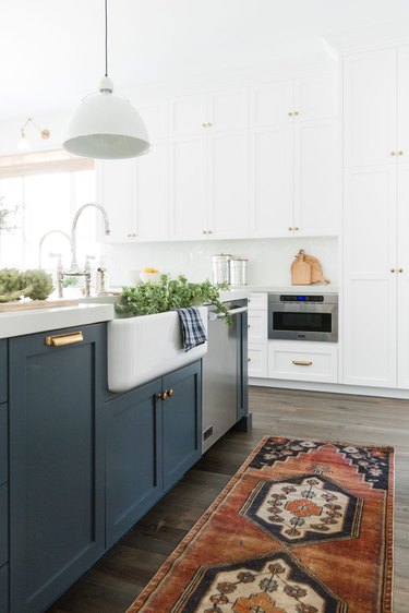 farmhouse-style kitchen with navy and white shaker cabinets