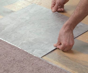 Setting a vinyl tile.