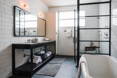 industrial bathroom with white subway tile and concrete countertop on vanity