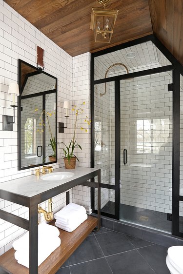 bathroom with subway tile and wood ceiling