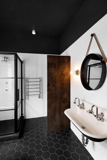 industrial bathroom with wall-mount sink and hexagon floor tile