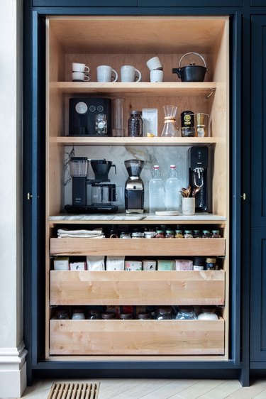 large coffee pantry with open shelving and pull out drawers for coffee