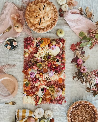 Designlovefest dining table for entertaining with charcuterie tray and pies