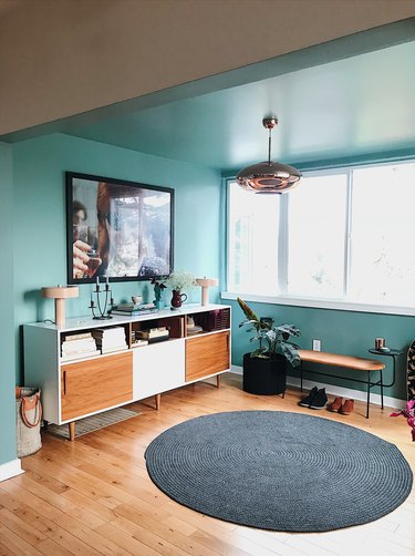 Designlovefest aqua blue entryway with credenza for storage and TV above