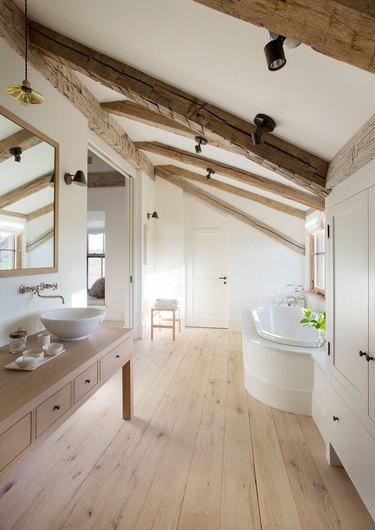 attic bathroom ideas with exposed beams and wood floor