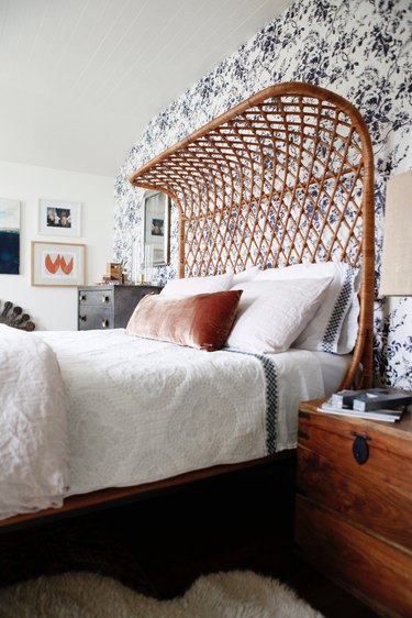 bedroom with rattan bed and toile feature wall