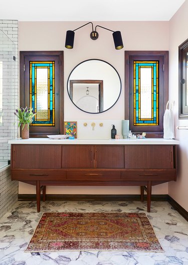 art deco stained glass windows in the bathroom above vanity cabinet