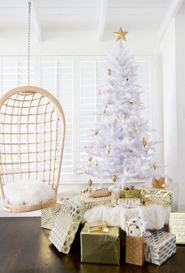 White tree, gold decorations, hanging chair