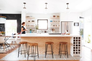 geometric Mexican tile floor in kitchen with open shelving and wood cabinets