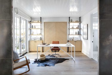 industrial pipe shelving in office with cowhide