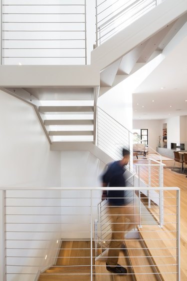 bright three-level staircase with light wood flooring and open layout