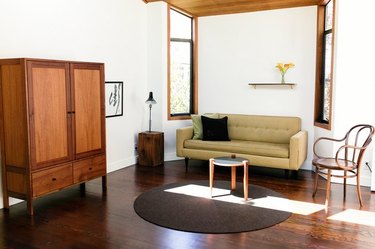 simple, clean living room concept with spare wooden furniture and art