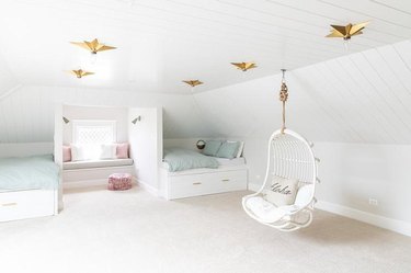 white swing chair in an attic playroom and bedroom
