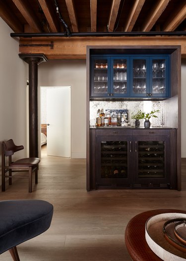 industrial bar idea in basement with blue and wooden cabinets