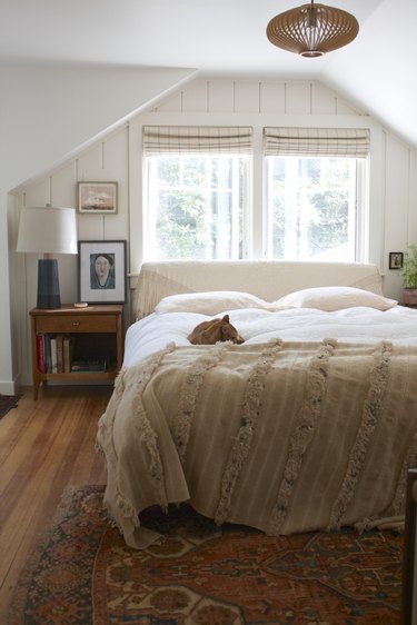 Attic bedroom idea with vintage furniture and framed prints
