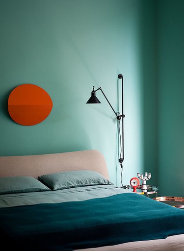 Red and turquoise complementary colors in modern bedroom