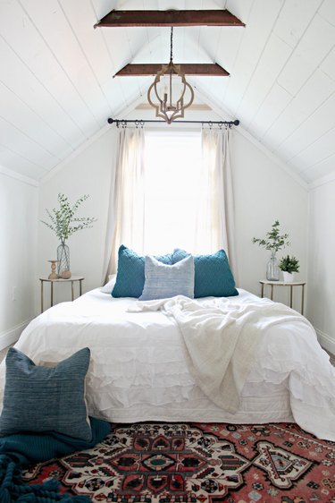 wooden beams in bedroom with slanted walls