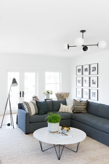 navy blue living room idea with sectional sofa and white walls