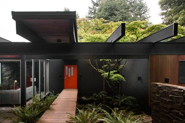 black midcentury modern exteriors with red doors