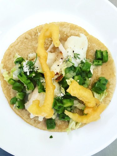 overhead photo of a taco on a white plate