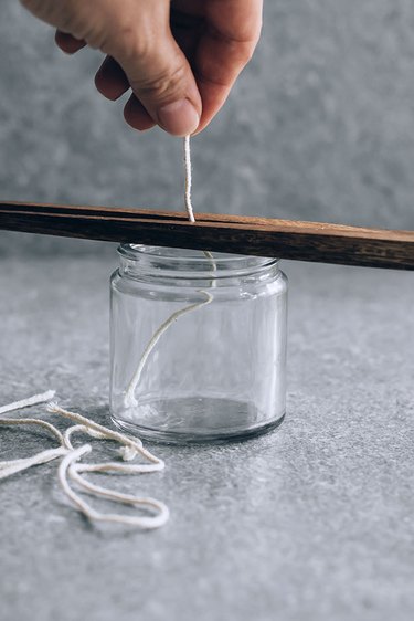 Getting wick ready for bug-repelling candle