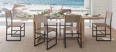 coastal furniture in a dining room overlooking the ocean
