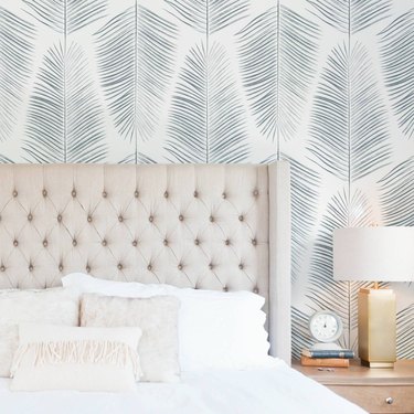 coastal wallpaper in coastal bedroom with palm print wallpaper