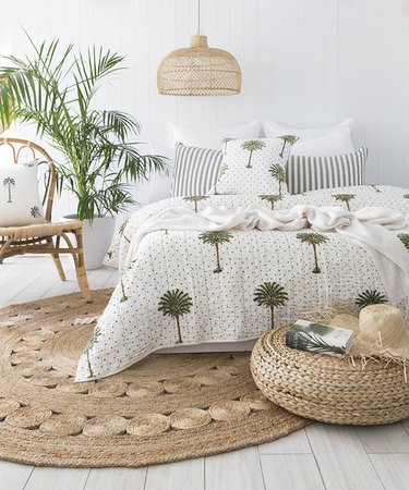 tropical bedroom with round area rug and wicker pendant light