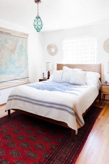 The master bedroom, with vintage furniture and light fixture.