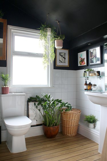 bohemian bathroom remodel with black walls and greenery