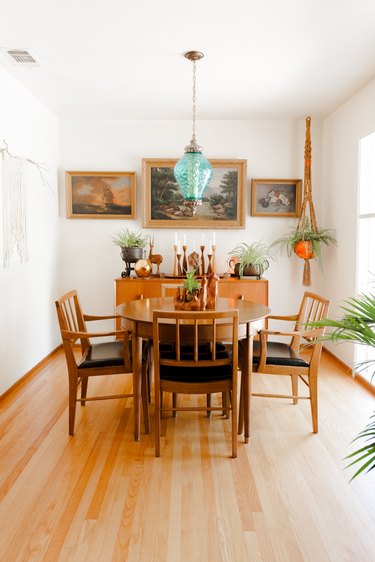 The dining area with three paintings that once hung in Steph's grandfather's home.