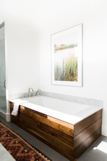 Modern bathroom with drop-in bathtub and wood surround