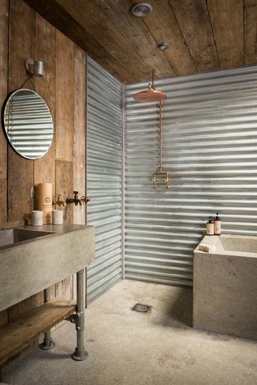 Reclaimed wood and concrete combined make this rustic bathroom utterly unique.