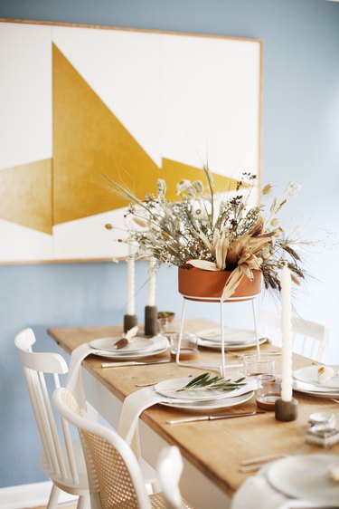 Dried floral fall centerpiece with terra cotta vase in modern dining room