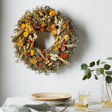 fall wreath made with marigolds and dried flowers