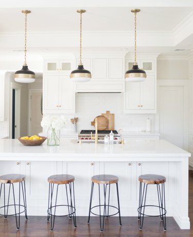 Modern coastal kitchen ideas in white kitchen three brass and black pendant lights